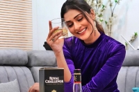 Payal rajput poses with royal challenge whisky bottle