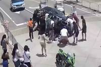 Viral video heroic onlookers police lift car to rescue motorcylist trapped underneath