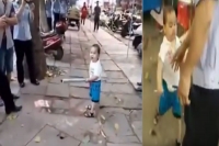 Chinese toddler protects family business against inspectors using a metal pipe