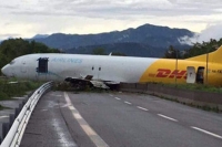 Cargo plane crashes onto busy italian road after overshooting runway