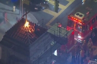 Man lights church cross on fire jumps from rooftop to rooftop in attempt to evade police