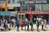 Liquor shops open women compete with men to purchase liquor in corporate centers