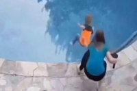 Woman catches son just in time and saves him from drowning in swimming pool