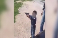 Proud turkish dad teaching his son how to shoot a handgun
