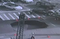Sinkhole opens up in middle of busy intersection in china