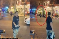 Street vendor tosses food from wok to man across street in viral video