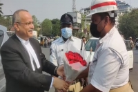 Telangana chief justice satish chandra sharma seen giving traffic cop a bouquet