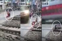 Watch mumbai biker s close shave with train captured in dramatic video