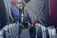 A flight was diverted after a passenger tried to open the plane door