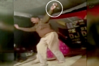 Drunk policeman showers money dances with bar girls