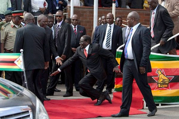 President robert mugabes guards sacked for allowing him to trip on red carpet